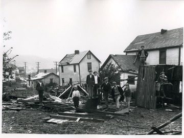 Children standing on the debris from a windstorm.