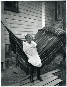 View of a small girl seated in a hammock in Morgantown, W. Va.