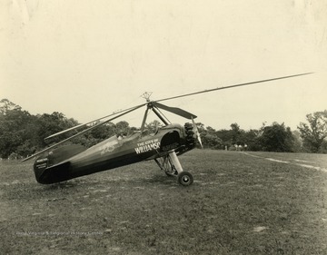 Pitcairn Autogiro plane.  Tail bears the number NC10768 with the number 28 on the side.  Printed under the wing are the words 'The heart of the billion dollar coal field'. Print number 792.