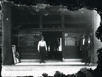 Three men standing in front of the Palace Cafe.