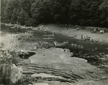 View of poeple gathered at Audra State Park swimming. 'Photo by conservation commission of West Virginia.'