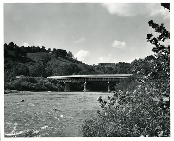 View of the Philippi Covered Bridge and a house in the distant in Philippi, West Virginia. The Philippi Covered Bridge was erected in 1852.