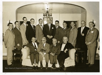 Group portrait of members of the Brooke County Bar which was taken in the William Country Club in Weirton, West Virginia. Seated left to right: Edward (Ned) George; C.K. Jacob; Judge JJ P O'Brien; and J.A. Gist. Standing left to right: James Park McMullen, Jr. Aloused C. Carman; Richard W. Barnes; Herman Rogersou; Hazlett Rodgers; R. E. Hagberg; Charles D. Bell; Clarence Spitznogle; Graham Nightingale; Walter E. Mokau; and Abraham Pruisky.