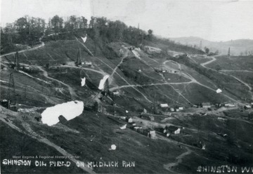 View of homes, oil derricks, and roads on a hillside on Mudlick Run at Shinnston.