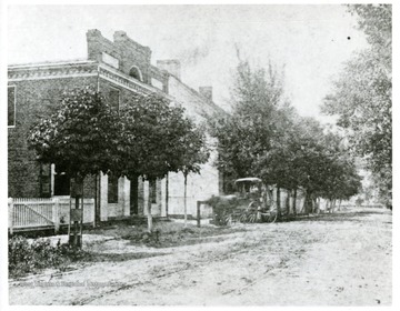 View of Main Street looking south. Store building at left now the Firestone Store 1953) has been in past years owned by various people, originally built.