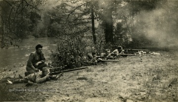 Group of students at Greenbrier Military School fire their rifles.
