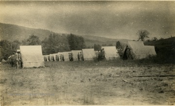 Military School students stand outside of their bivouac shelters for inspection.