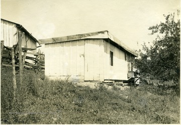 A simple shed-roof poultry house, 10' x 31' with nests and perches. From photo album labeled 'Stewart A. Cody, County Agent, Jackson County, 1912.'