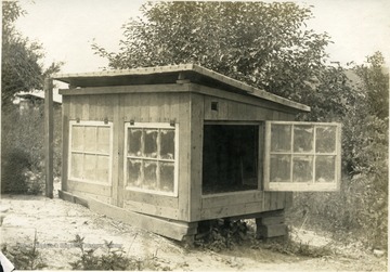 'Brooder house of Mr. Frank McPherson, Crow Summitt. Size 4' x 8' and a universal hover. A type of colony brooder considerable above the average.' From photo album labeled 'Stewart A. Cody, County Agent, Jackson County, 1912.' 