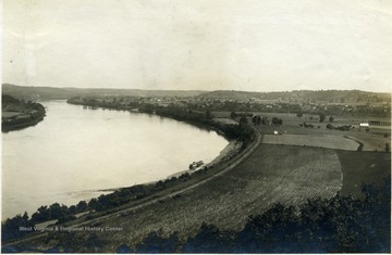 'The Ohio River, showing the town of Ravenwood and the bottom land of the West Virginia side. This bottom land is most noticeable from Muses bottom to the Schoolhouse.' From photo album labeled 'Stewart A. Cody, County Agent, Jackson County, 1912.'