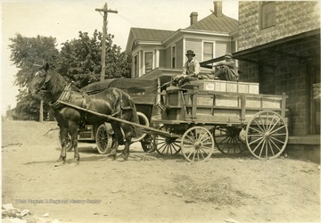 'Hauling a load of candled eggs from the produce house to the refrigerator car to be loaded for shipment to Pittsburgh.'  From photo album labeled, 'Stewart A. Cody, County Agent, Jackson County, 1912.'