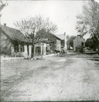View looking North on King Street. Miss Ellen Welshan's shop; Mr. Steve Dandridge's office and implement shop; houses; Mr. B. Baker's Store, now Kave's; old fire hall and shed, later a jail, and now the Women's Club.
