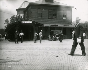 A scene of people coming and going from the Weston Train and Trolley Station.
