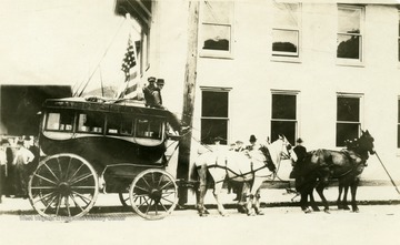 A horse-drawn carriage stops at West 2nd Street alongside the Bailey House.