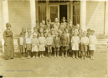 View of a class from Haywood School persons in the photo include: Paul Stackpole, Nile Martin,Rosa Chicrello, Pat Campbel, Denzel Bird, Leo Hewet, Maude Powell, Carl Robinson, Beatrice Voyle, Anna Coaltrane, Anna Heyo, Buster Preston, Ted Rubble, Mary Kinsley, Katheryn Pribble, Richard Right, ? , Margaret Campbel, Annetta Sharp, John Muskrock, Steve Muskrock, Laura Powell, Everette Martin, Troy Baker, Raymond Chilleo, Madge Baker, Glen Perine, William Sharp, Anna Muskrock, Opal Preston, Kenneth Towles.and Teacher Mrs. Gerta Robinson.