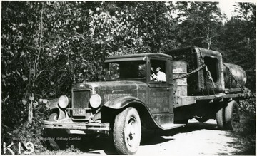 This is a large truck operated by the Hamlin Transfer Company, in Hamlin, W. Va., loaded with well drill machinery which is being transported by truck from near Breeden, W. Va., to East Lynn, W. Va. This picture was made in the County Road on Twelve Pole Line about one-half mile above Doane, W. Va.