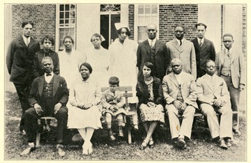 Superintendent and staff pose for a group portrait in front of the State Hospital for Colored Insane, Mason County, West Virginia.