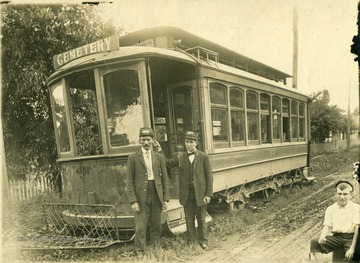 'Scene from Virginia Avenue'in Mercer County. Two men stand outside of the train car and a young boy sits in the bottom right corner.