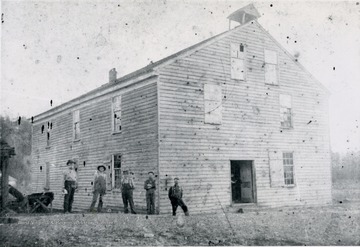A view of the old wooden mill at Hollywood. The men in the picture are: 'Stewart Vandegrift, Clarence Bostic, Newton Van Stavern, Osbie Surfice, and Amos Vandegrift'.