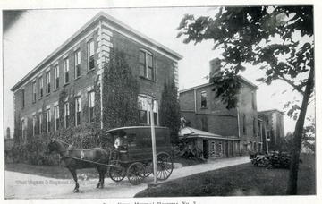 Rear view of Miners' Hospital Number 3 and a horse drawn ambulance.
