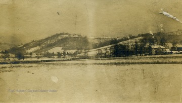 Winter view of Hans Creek Valley Included in the image are: J.E. Ellison's house before it was remodeled, the Larew barn before the big house was built. The Mill house and the mill.