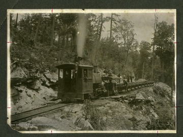 Train and coal cars on the tracks.