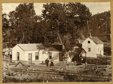 'Cubby Bair says: first home of Dr. A.S. Abshire, Crow, where Charles Jordan now lives. He first came from Roanoke, then from Hinton, went out to Crow as company doctor for J.R. Beaty Lumber Company. In picture is Dr. and Mrs. Abshire (she was Cubby's aunt, a sister of Fred Bair). This railroad shown is a part of the company built-owned, first rails to be laid in Raleigh county. The track stretched from the New River up Glade Creek, through new tunnel at top of Crow Ridge, down to Beaver, Raleigh, up. Happy Hollow to the little station below Beckley Seminary.'