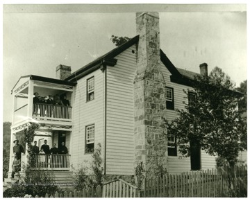 Mary Ann Byrd Home, August 4th, 1896.  On upper porch:  Ona E. Davis, Ernest Byrd, Dan Byrd, Adelaide S. Davis, Elsie Byrd.  On lower porch:  George W. Davis (seated), John W. Byrd, Luna Harman, Virgil Harman (baby), Walter S. Harman, Phebe M. Byrd, Mary Ann Byrd.