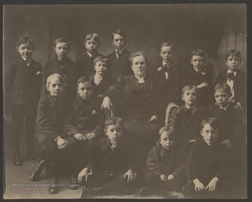 In the front row, from left to right, is Terrence Moorefield, Fred Brown, and Boyd Brown.In the second row, from left to right, is Christian Hetzel, George Griffith, Clemmer Peck, Mrs. Carrie B. Mahon (teacher), Reese Capeller, and Stanely Butler.In the back row, from left to right, is William Moorefield, Cecil Hinton, Julian Fredeking, Roy Mann, Oswald Blackwilder, Leo Ross, and Fred Flanagan.