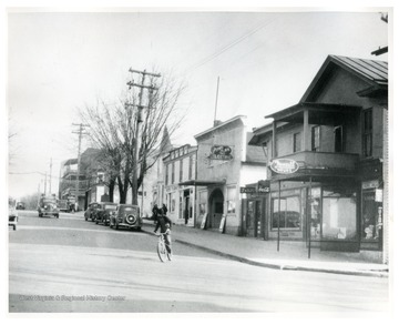 Child riding bike on Main Street in Harrisville.