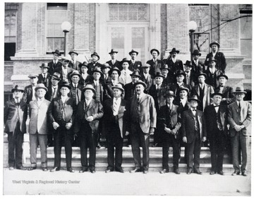 Brotherhood of railway engineers standing in front of the main entrance of Hinton High School on Temple Street in Hinton.