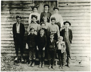 'First row, left to right: Walter Painter, Ray Bodkin, Lon Bodkin, Tommy Painter. Second row, left to right: Parion Cowger, Jessie Painter, Lynn Conrad, Lola Cowger, Myrtle Hevener, Oscar Painter. Third row, left to right: Ola Homan, Jessie Hammer (Teacher), Fanny Conrad.