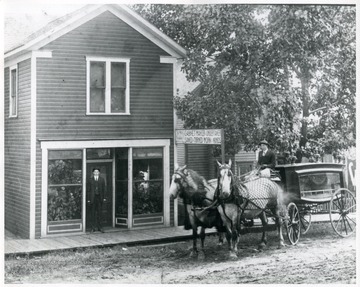 Horse Drawn Hearse in front of Mott Business.