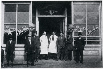 A few men stand in front of the 'White Star Saloon'.