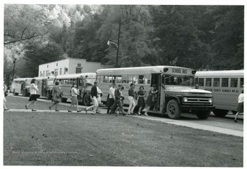 "At 3:30 p.m. 'students rush out to buses waiting to be loaded.'" Webster County Students Boarding Buses, Webster County, W. Va. 