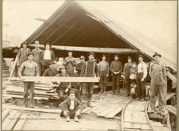 Right- Luther Wiles of Ruthbelle, W. Va. Left- Charey Lants of Aura, W. Va. (holding flank, back row),  _, Charles Homes, Shilo Dumire of Elkins, W. Va., Oliver England (setting down), Joseph Summers (sitting down), Ely Wilfong, _ Helmick, Charles Poling of Elkins, W. Va., Elmer Dumire, French Renick and daughter of Parson, W. Va., Isac Wilfong of Montrose W. Va., Dave Wilhelem (boy sitting down).  