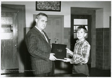 In the Spring of 1968 the Record Book Class were freshmen.  David Gilkeson, president of the class, is briefed on the book by principal Robert G. Andrick.