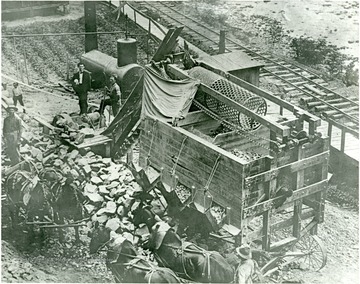 View of men and horses at a rock crusher in Webster Springs.