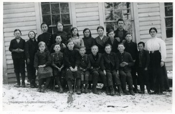 Group of children outside with their teacher at Cold Knob, Webster County, W. Va. Cold Knob School was located on Laurel Run of the Gauley River.