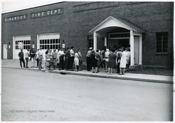 People lined up outside of the Kingwood Community Building.