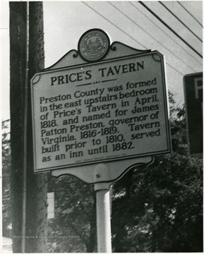 A close-up view of Price's Tavern Historical Marker in Preston County, West Virginia. 'Preston County was formed in the east upstairs bedroom of Price's Tavern in April 1818, and named for James Patton Preston, governor of Virginia, 1816-1819. Tavern built prior to 1810, served as an inn until 1882.'