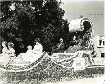 Alonzo D. Naylor on a float at the Terra Alta Parade.  Sign reads '102 years old today.'