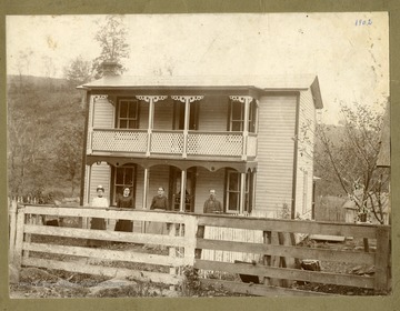 Three ladies and a man are standing in front of Tom Watkins' home in Marquess, Preston County, West Virginia.