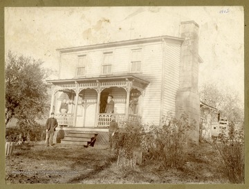 Tom and his wife are standing on the front porch while Dent Summers, right and Russell Summers are standing on the ground of Tom Summers' home in Marquess, Preston County, West Virginia.