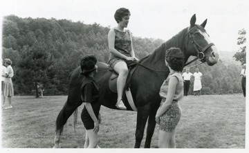Queen Ceres XXII of Tunnelton, Miss Nancy Trickett (on horse), along with the Maids of Honor, Kay Hauser and Connie Graham.