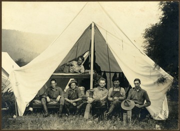A group portrait in a tent, of the Deakins Line Surveying Team of Preston County, West Virginia.