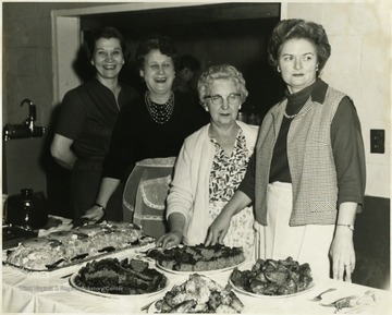 Four unidentified women pose with the food.