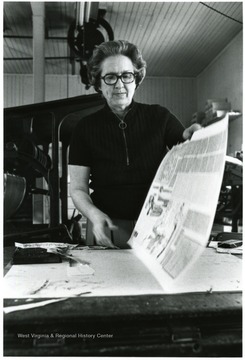 View of Mrs. Jane Price Sharp looking over proof pages of her Marlinton, W. Va. weekly paper, The Pocahontas Times.