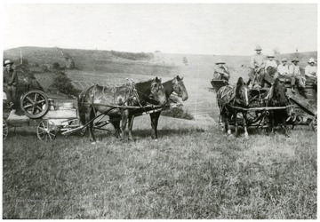 "This is a 'Threshing Machine Crew' holding a 'Mons Thresher.'  They would move from one farm to the next and thresh the stacked wheat or oats.  The grain could not be threshed standing dead ripe in the fields as it is today.  It was reaped and shocked in the fields (about 12 bundles to a shock), cured out and then ricked or stacked.  Later the Threshing Crew moved in and threshed.  The earliest used oxen power and later came steam power.  Even later, gasoline powered ones were used.  This one was the steam powered.  This picture was taken in the Sugar Grove/Little Indian Creek area off the old Morgantown/Fairmont Pike.