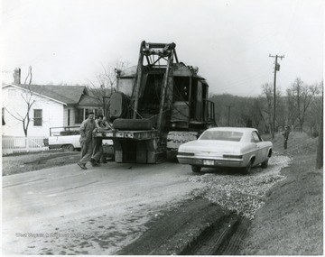 Car passing a road construction vehicle.  
